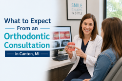 Orthodontist explaining braces treatment during an orthodontic consultation with a patient in Canton, MI.