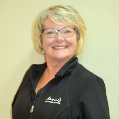 Dolly, Masri Orthodontics staff member, smiling and wearing glasses.