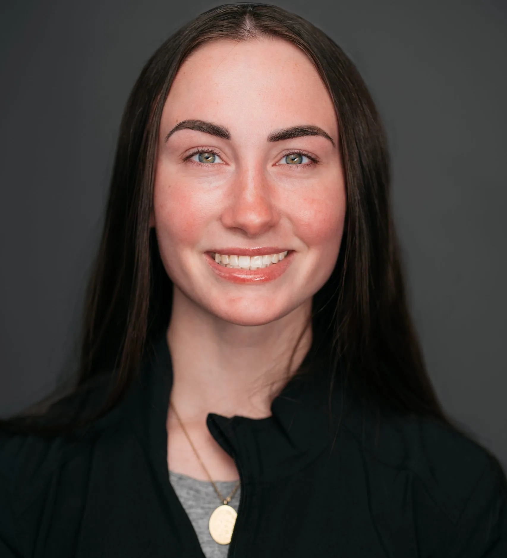 Orthodontic assistant Sarah smiling in professional portrait, Masri Orthodontics team member.