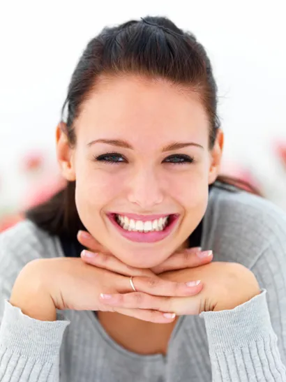 Smiling woman resting her chin on her hands