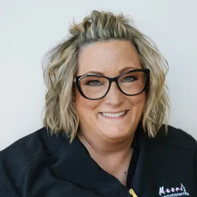 Masri Orthodontics team member Christy smiling and wearing glasses.